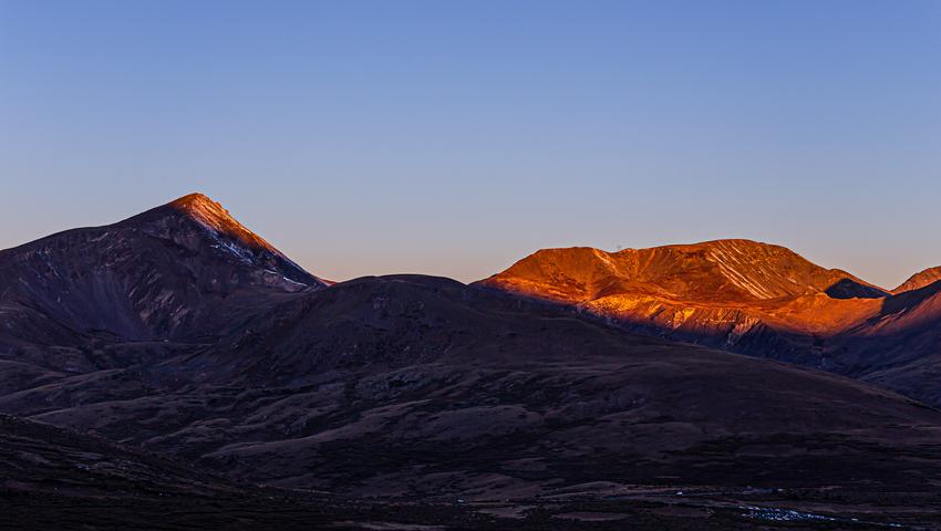 Mountains with early morning sunlight shining on the summits
