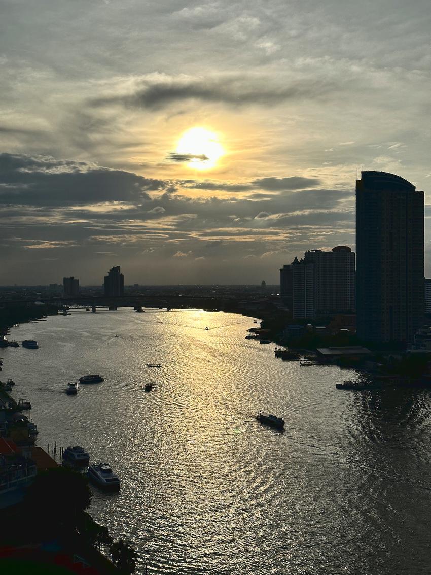 A view down the Chao Phraya river with the sun close to the horizon