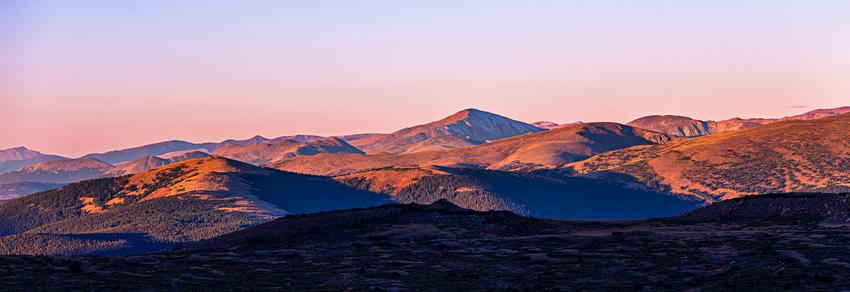 A range of mountains with early morning sunlight shining on them